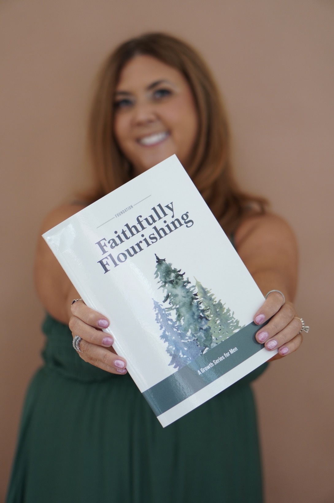 Ginger holding the Faithfully Flourishing Foundation book